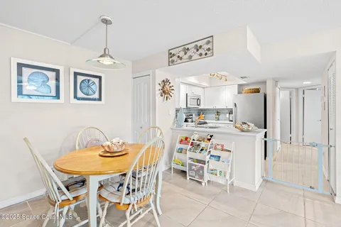 a white kitchen with a sink and stove top oven