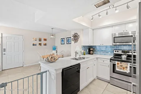 a view with a sink and livingroom with wooden floor