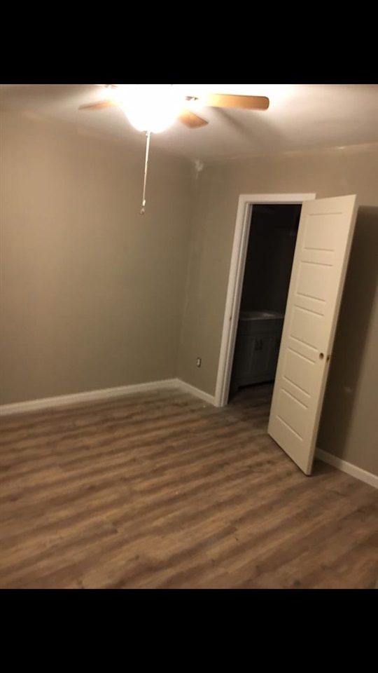 1071 Getwell Road Memphis, TN 38111 - Photo 3 of 6 a view of an empty room with wooden floor