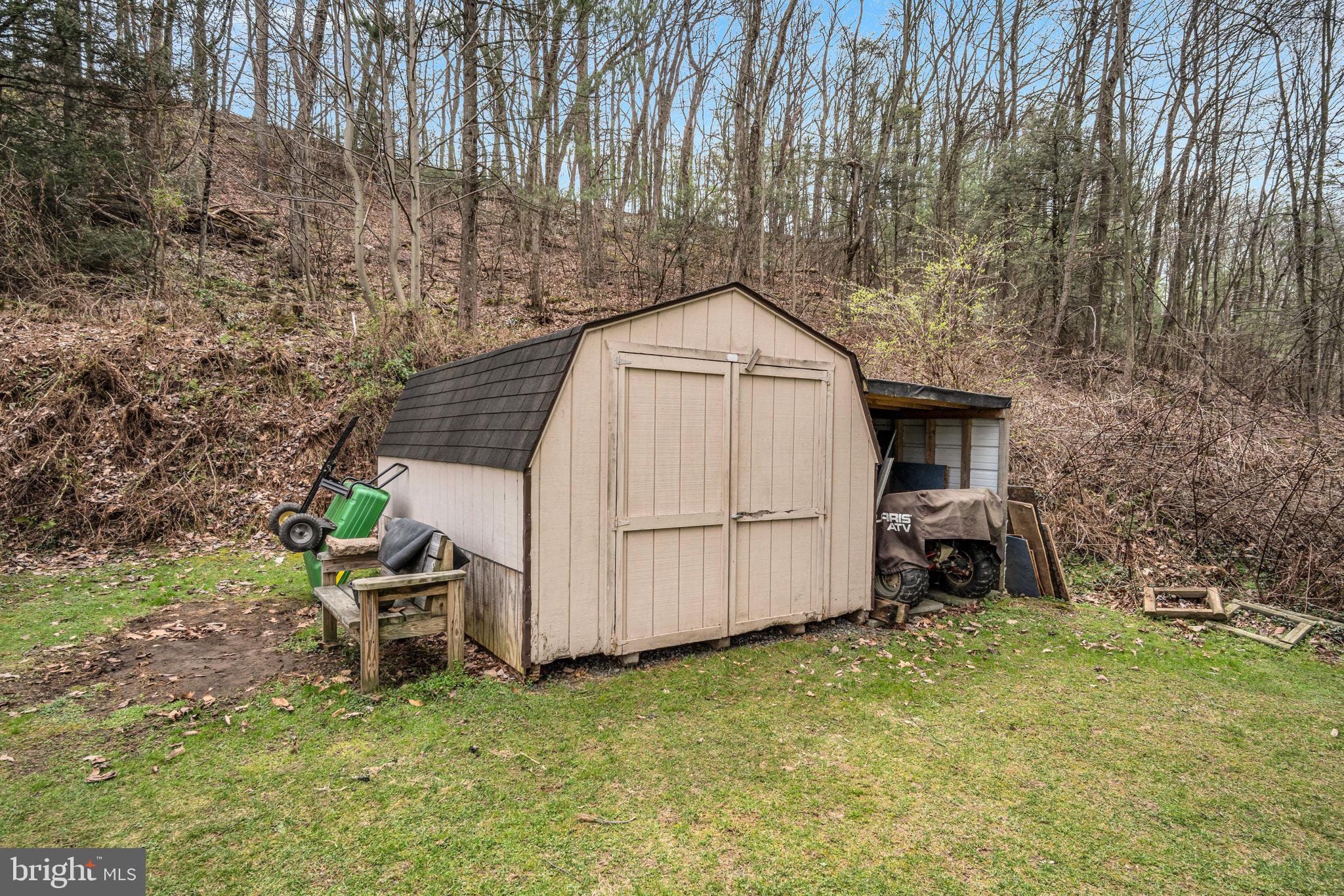 155 Greenbriar Road Elliottsburg, PA 17024 - Photo 34 of 38 Charming shed nestled in nature's embrace.