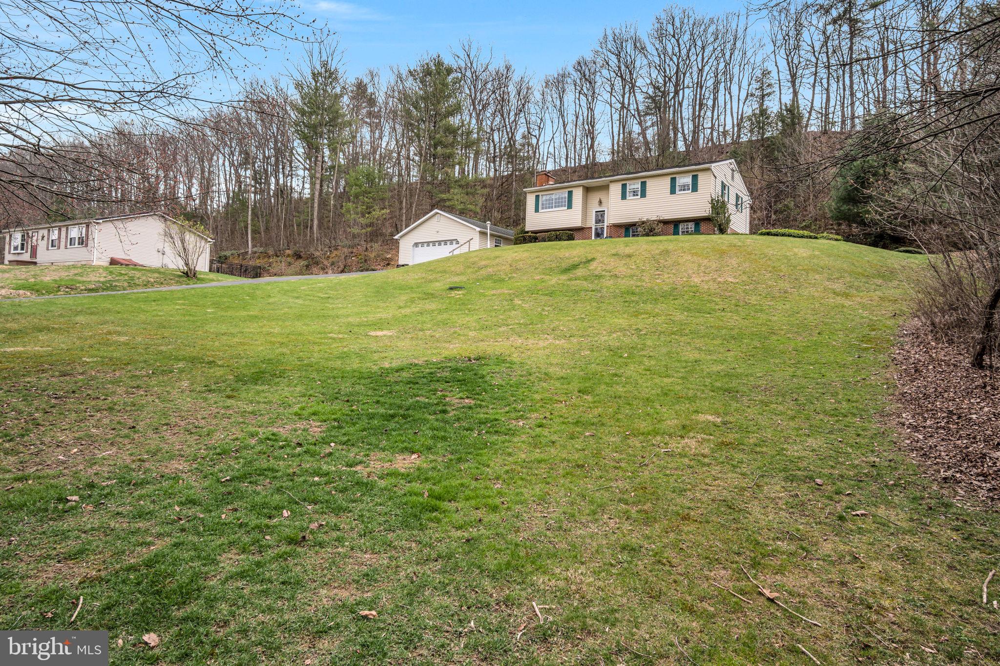 155 Greenbriar Road Elliottsburg, PA 17024 - Photo 4 of 38 Charming hillside home with lush greenery.