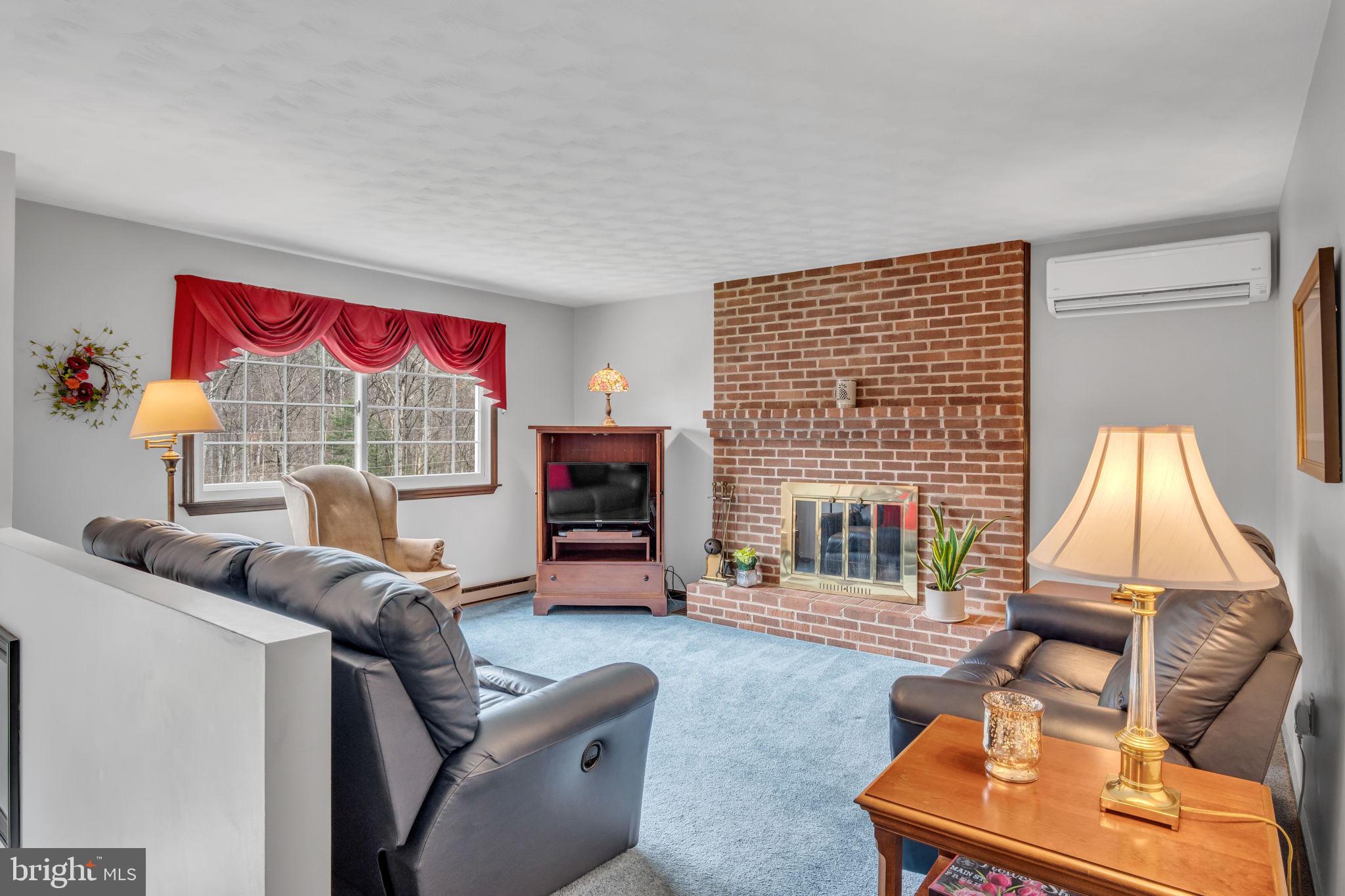155 Greenbriar Road Elliottsburg, PA 17024 - Photo 6 of 38 Cozy living room with brick fireplace.