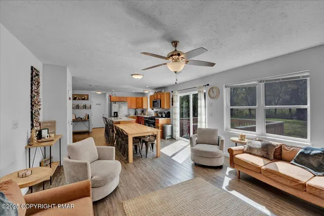 a living room with furniture a fireplace and a flat screen tv