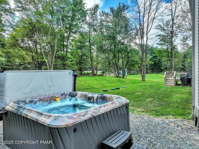 a view of an chairs and table in the backyard