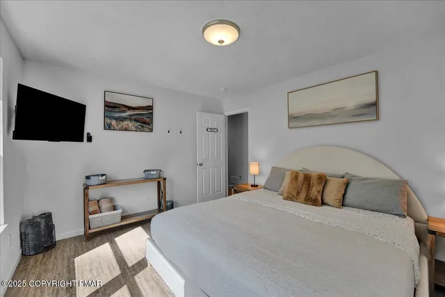 a bedroom with two beds and a flat screen tv