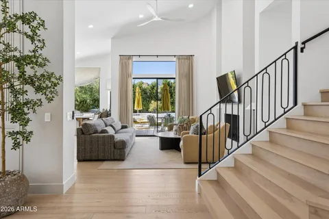 a living room with furniture and stairs