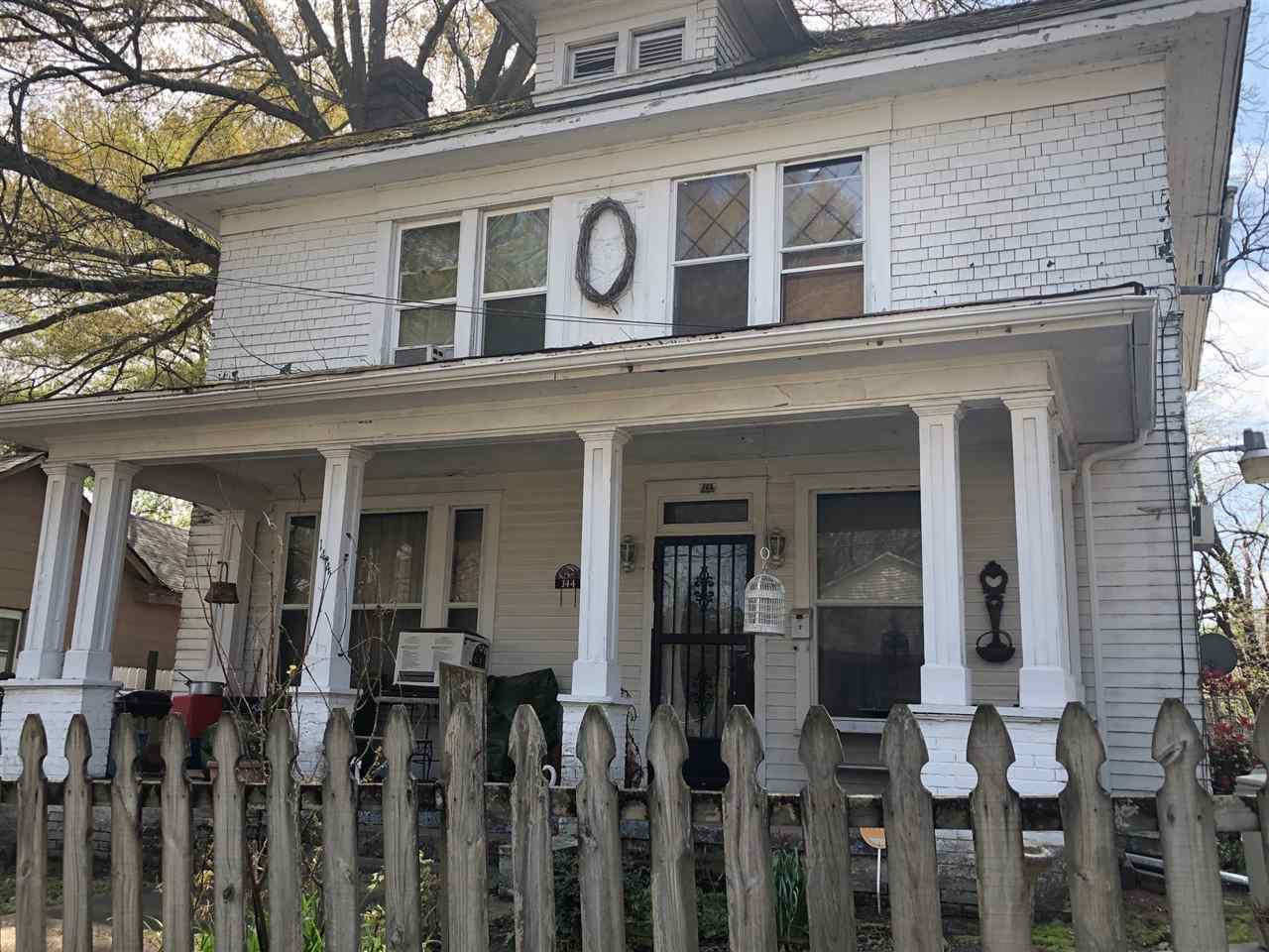 a view of a house with wooden fence