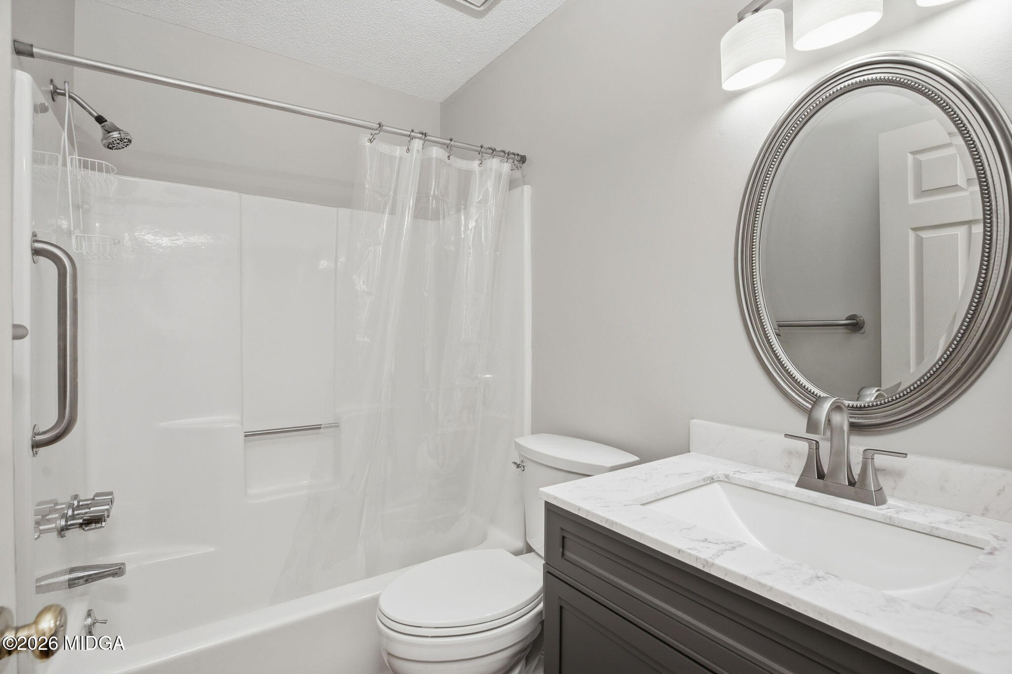 108 Manor Terrace Macon, GA 31210 - Photo 11 of 23 a bathroom with a granite countertop sink toilet a mirror and shower