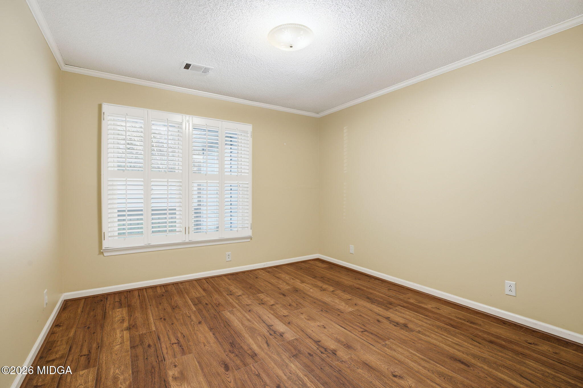 108 Manor Terrace Macon, GA 31210 - Photo 13 of 23 a view of an empty room with wooden floor and a window
