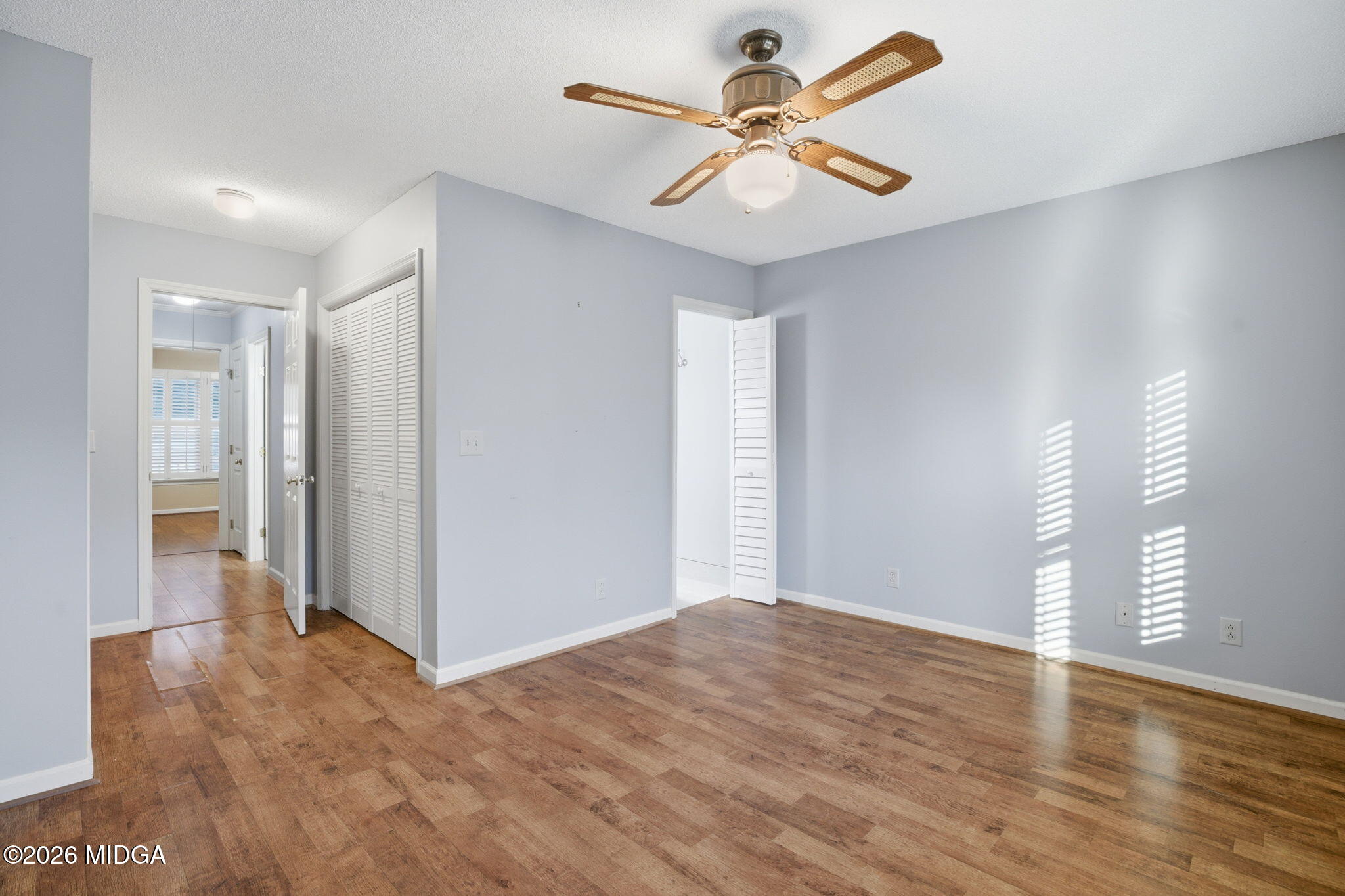 108 Manor Terrace Macon, GA 31210 - Photo 14 of 23 a view of a big room with wooden floor and a ceiling fan