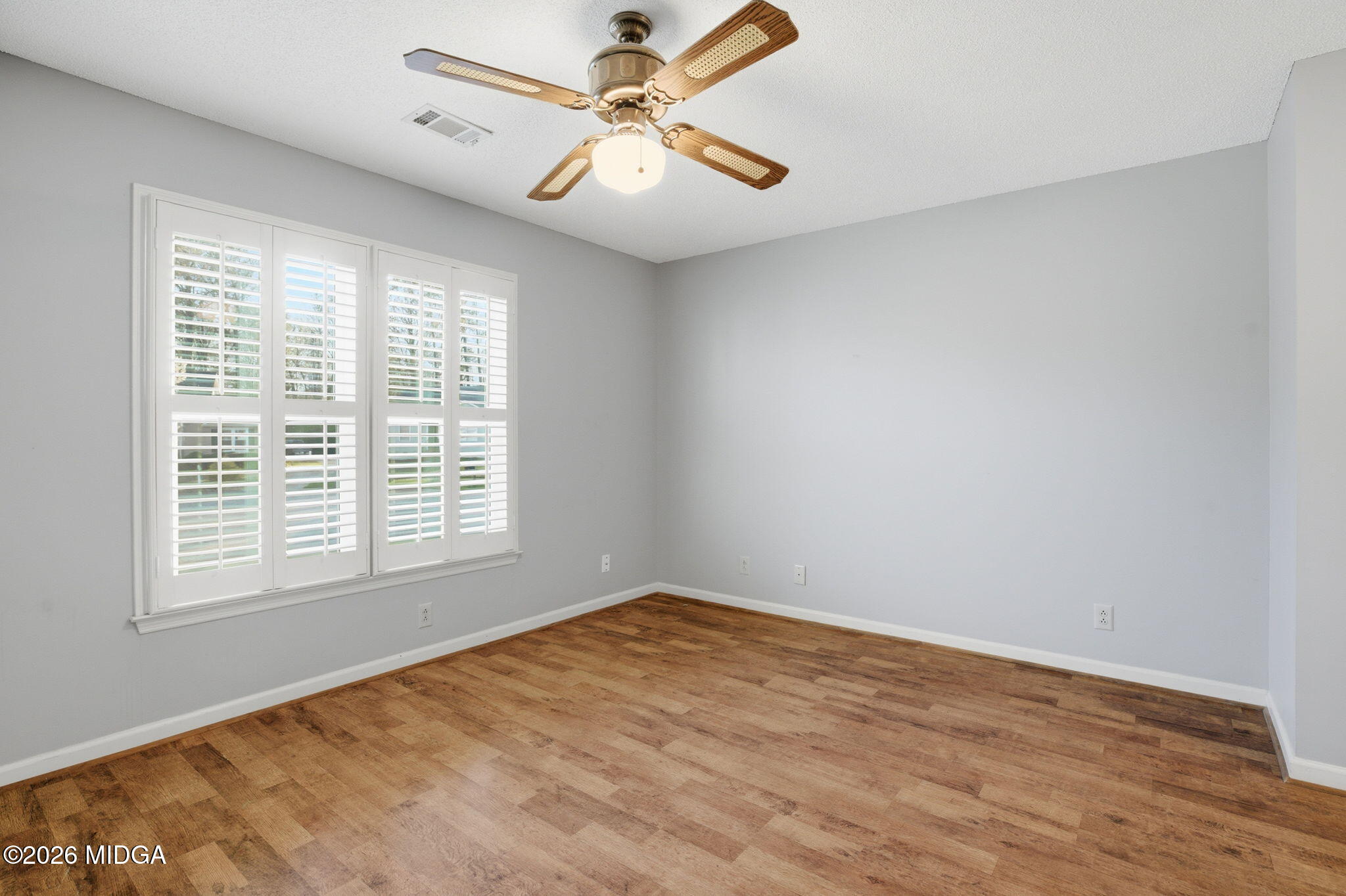 108 Manor Terrace Macon, GA 31210 - Photo 16 of 23 an empty room with a window and a fan