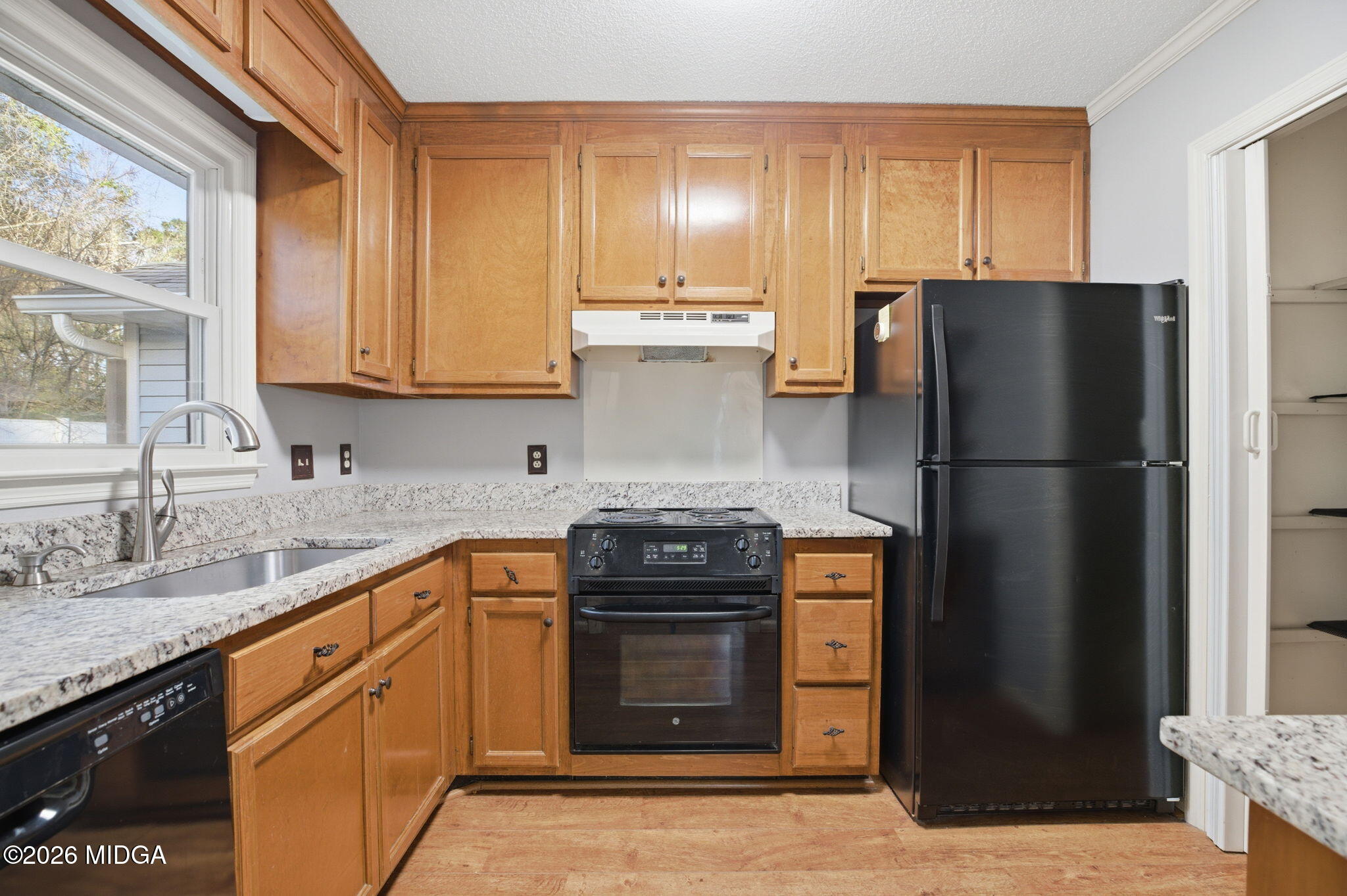 108 Manor Terrace Macon, GA 31210 - Photo 8 of 23 a kitchen with granite countertop a refrigerator stove and cabinets