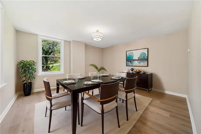 a view of a dining room with furniture window and wooden floor