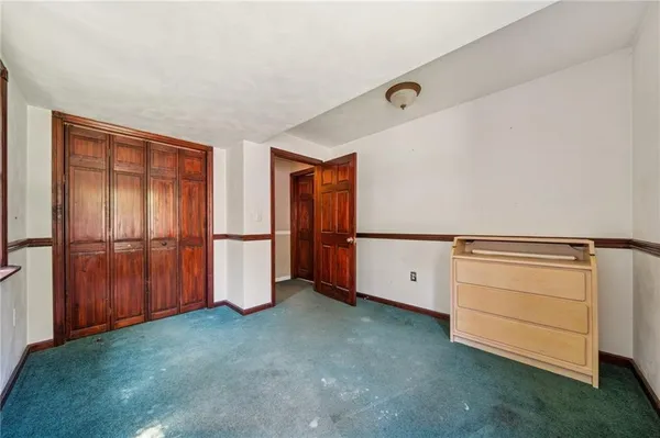 a view of an empty room with closet