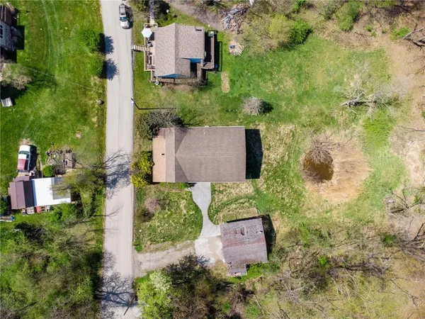 an aerial view of residential house with outdoor space and parking