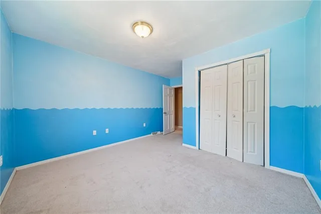 a bedroom with a bed a dresser and potted plants