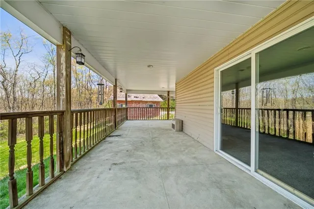 a view of a porch with wooden floor and fence