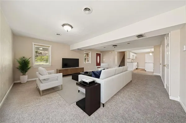 a living room with furniture and a flat screen tv