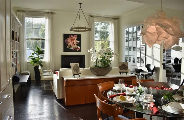 a living room with furniture a chandelier and a fireplace