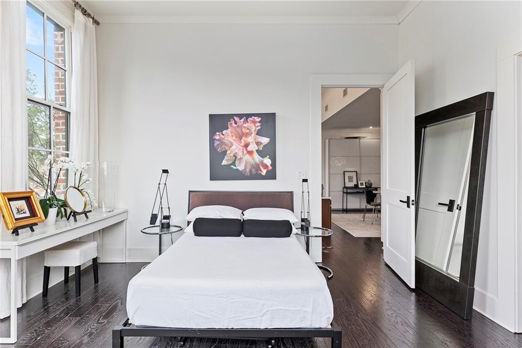 10625 Serenbe Lane, Unit 204 Chattahoochee Hills, GA 30268 - Photo 13 of 20 a bedroom with a bed and a table with chair