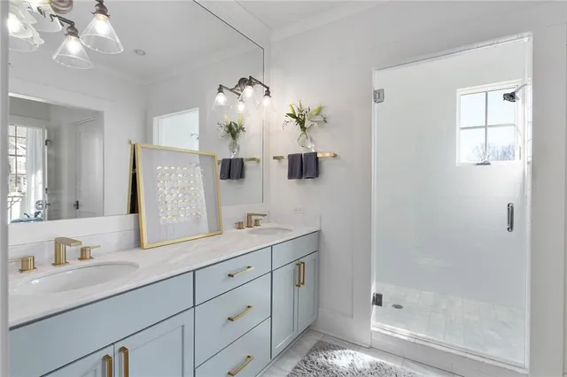 a bathroom with a double vanity sink mirror and shower