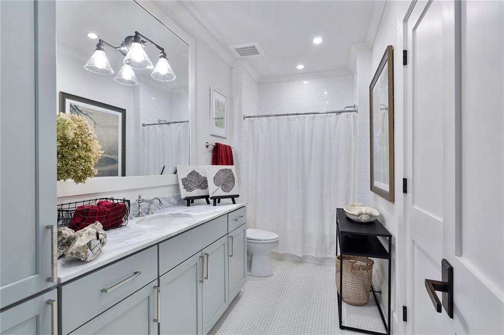 10625 Serenbe Lane, Unit 204 Chattahoochee Hills, GA 30268 - Photo 19 of 20 a bathroom with a sink vanity granite and toilet