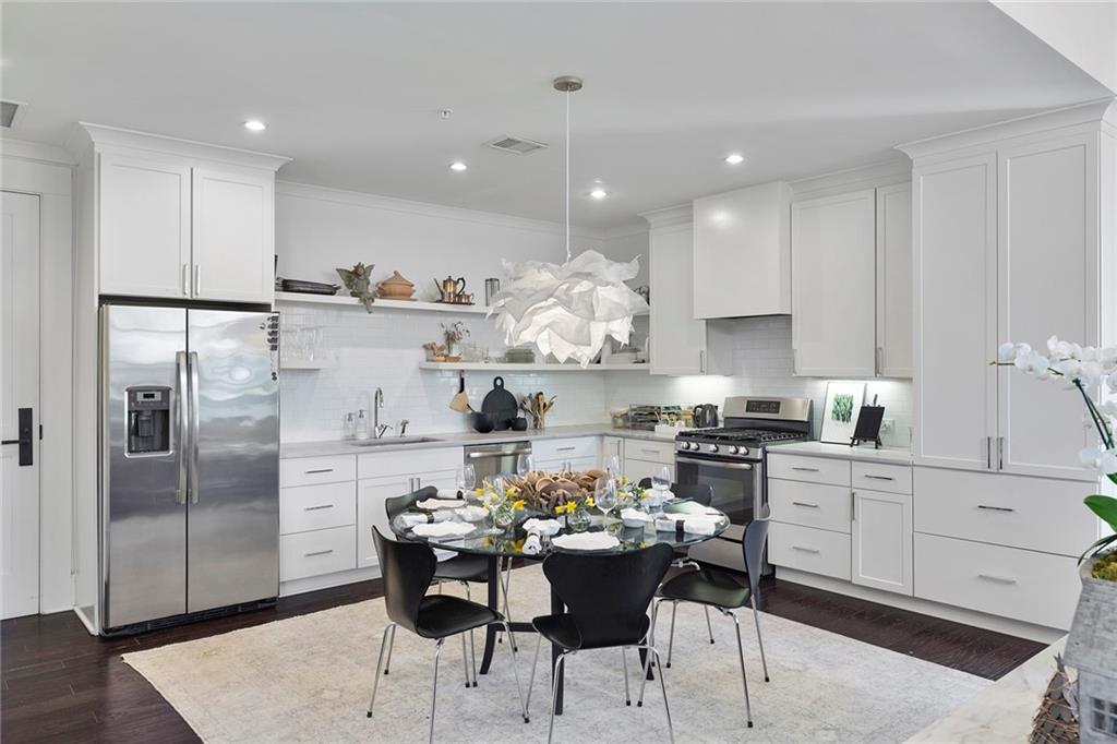 10625 Serenbe Lane, Unit 204 Chattahoochee Hills, GA 30268 - Photo 4 of 20 a kitchen with stainless steel appliances kitchen island granite countertop a sink and refrigerator