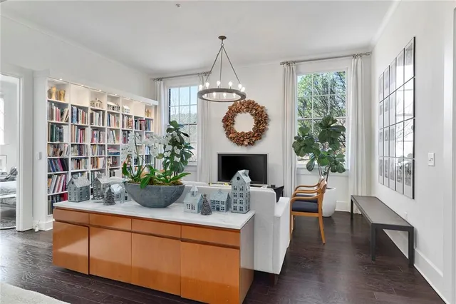 a living room with fireplace furniture and a large window