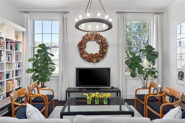 a living room with furniture a flat screen tv and a fireplace