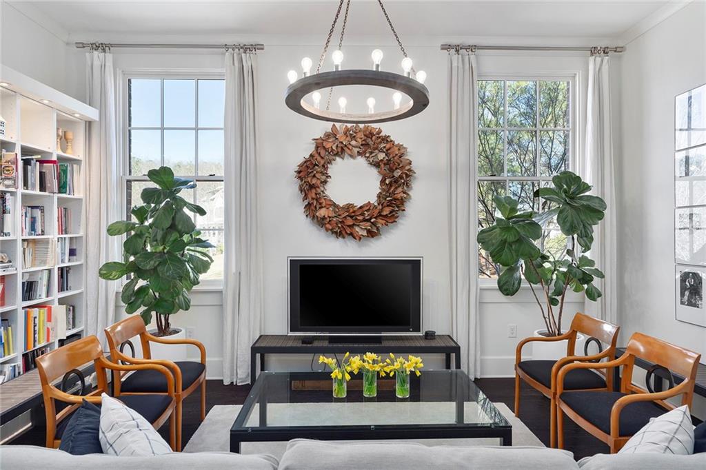 10625 Serenbe Lane, Unit 204 Chattahoochee Hills, GA 30268 - Photo 10 of 20 a living room with furniture a flat screen tv and a fireplace