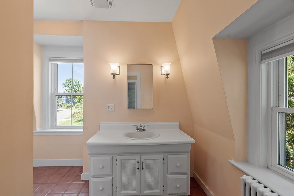 84 A Granite Street, Unit A Rockport, MA 01966 - Photo 19 of 40 a bathroom with a sink a vanity and a window