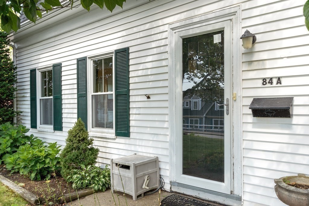 84 A Granite Street, Unit A Rockport, MA 01966 - Photo 23 of 40 a view of a entryway door front of house
