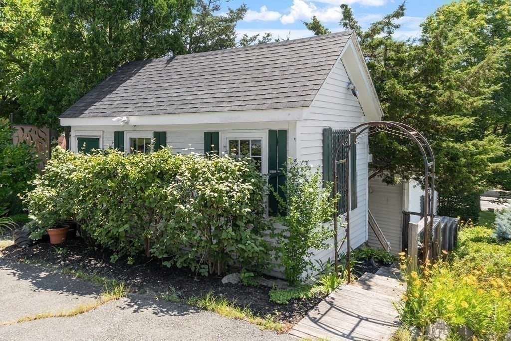 84 A Granite Street, Unit A Rockport, MA 01966 - Photo 27 of 40 a view of a white house next to a yard