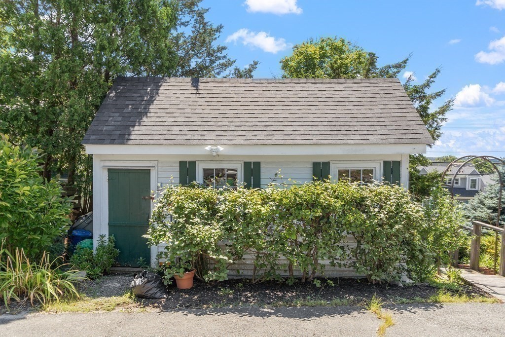 84 A Granite Street, Unit A Rockport, MA 01966 - Photo 28 of 40 a front view of a house with a yard