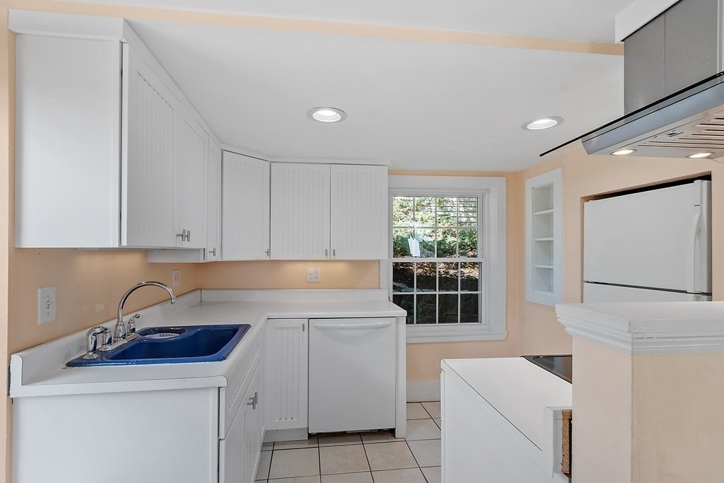 84 A Granite Street, Unit A Rockport, MA 01966 - Photo 6 of 40 a kitchen with a sink cabinets and window