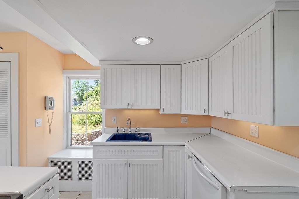 84 A Granite Street, Unit A Rockport, MA 01966 - Photo 8 of 40 a kitchen with a sink cabinets and window