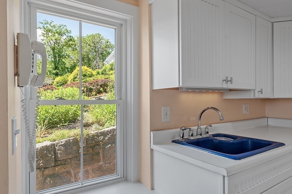 84 A Granite Street, Unit A Rockport, MA 01966 - Photo 9 of 40 a kitchen with a sink and a window