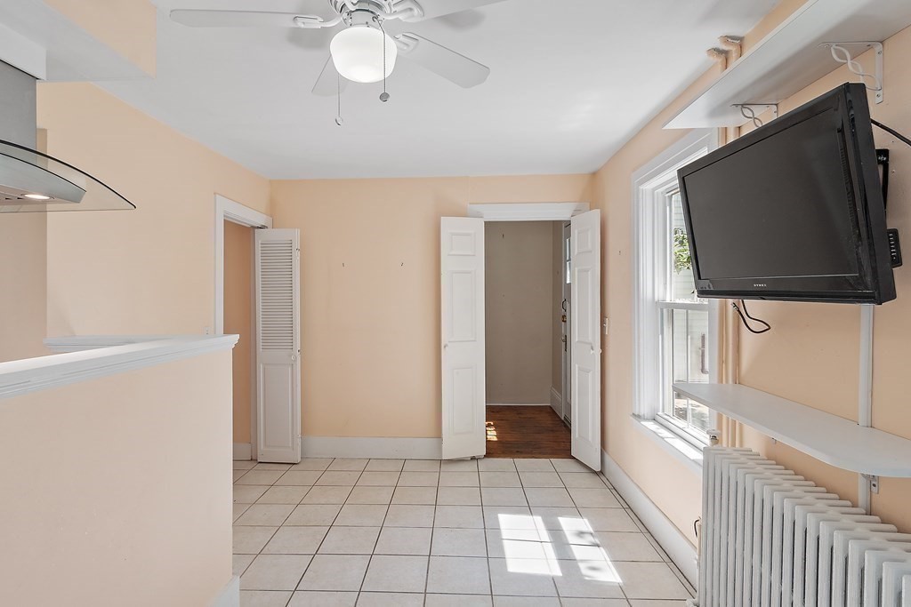 84 A Granite Street, Unit A Rockport, MA 01966 - Photo 10 of 40 a view of a livingroom with an empty space and a flat screen tv