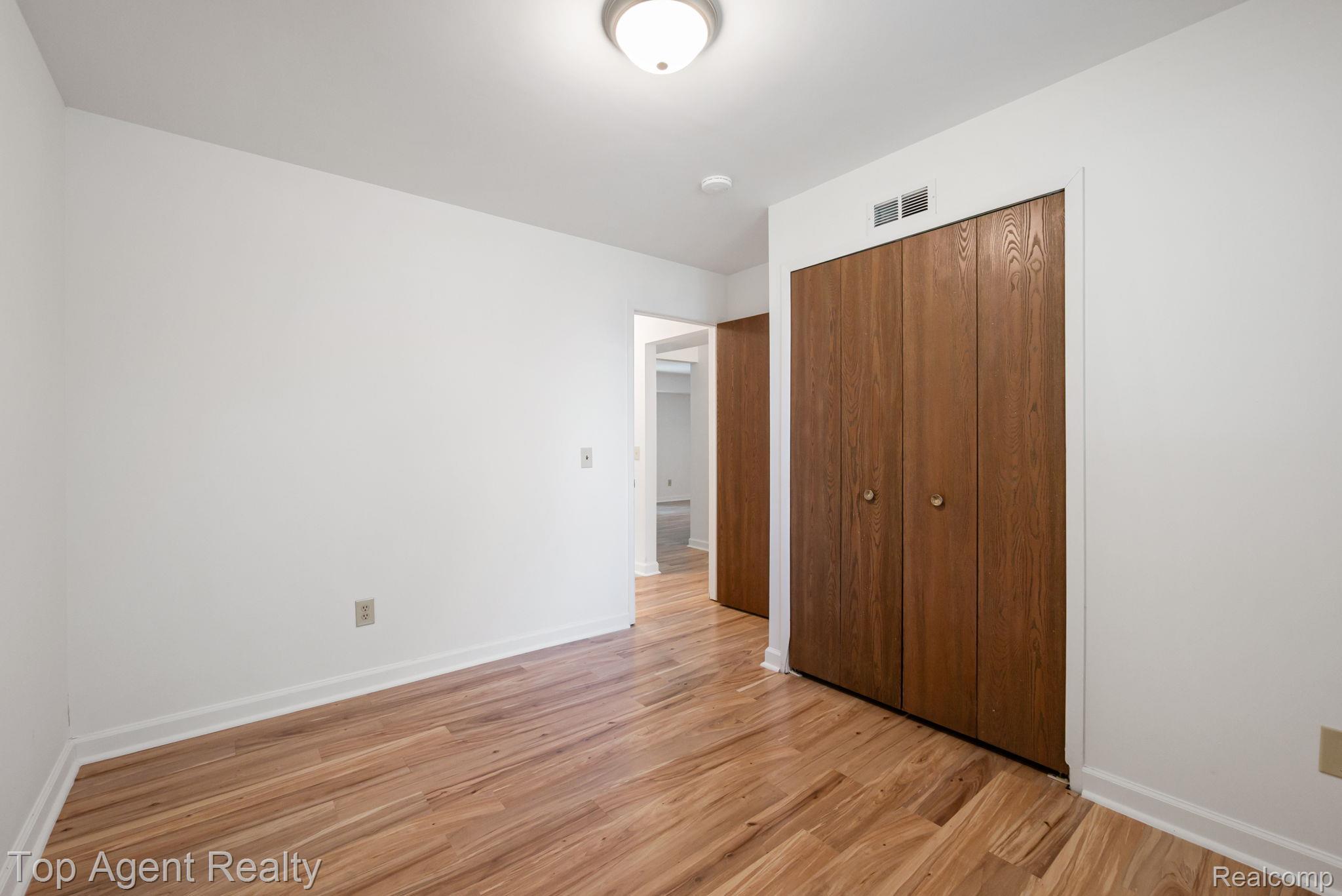 23420 Middlebelt Road Farmington, MI 48336 - Photo 22 of 32 Wood-finish flooring, white walls, and a ceiling-mounted light fixture
