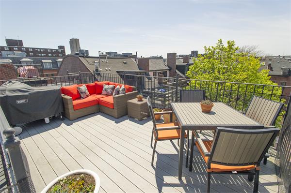 a view of a terrace with a table and chairs