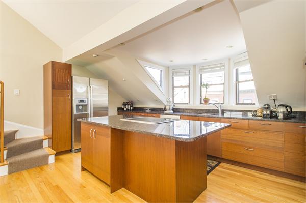 38 Worcester Street, Unit 3 Boston, MA 02118 - Photo 2 of 15 a large kitchen with stainless steel appliances wooden floor and a large window