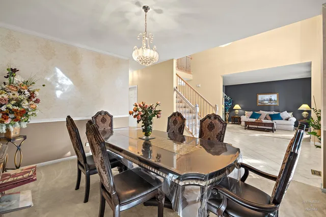a view of a dining room with furniture and chandelier