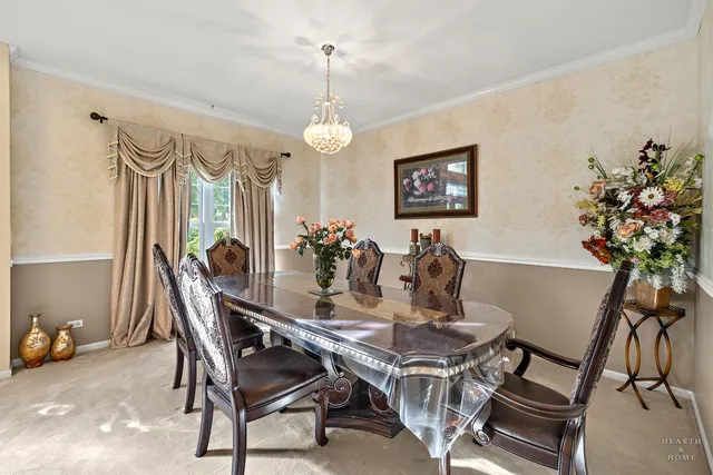 a view of a dining room with furniture and a chandelier