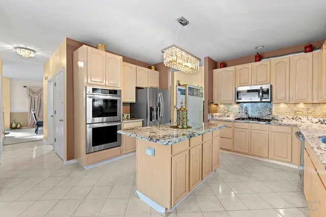 a kitchen with a stove top oven and refrigerator