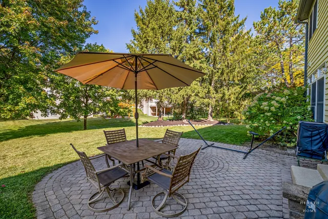 a view of an outdoor sitting area with furniture and umbrella