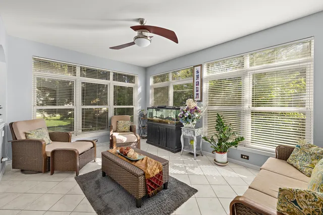 a living room with furniture and potted plants