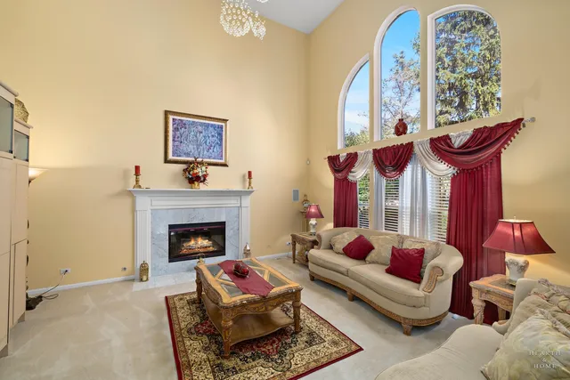 a living room with furniture a fireplace and window