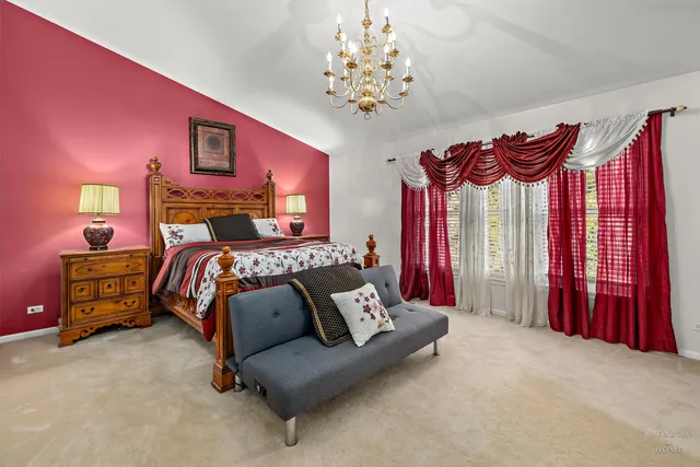 a bed room with a bed and a chair