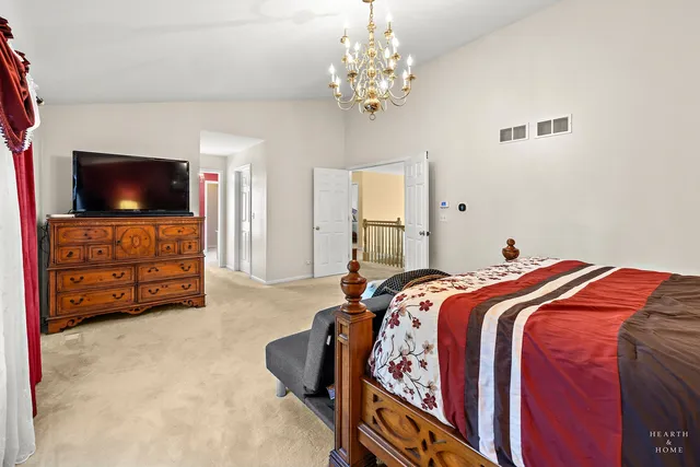 a bed room with a bed television and a couch