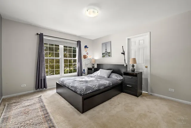 a spacious bedroom with a bed and a window